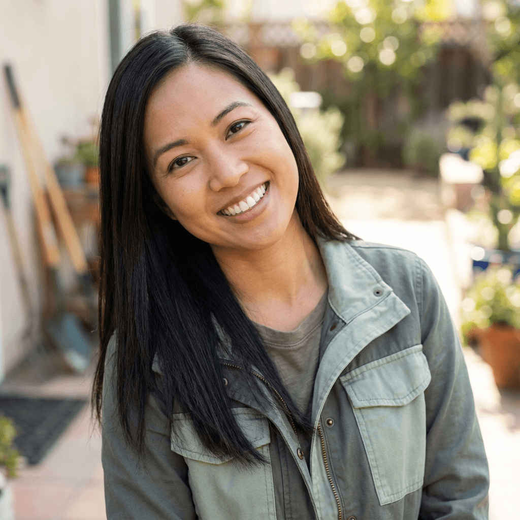 Smiling homeowner standing by her kitchen sink